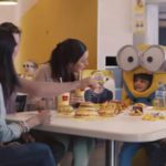 Child wearing Minion costumer with family at McDonalds