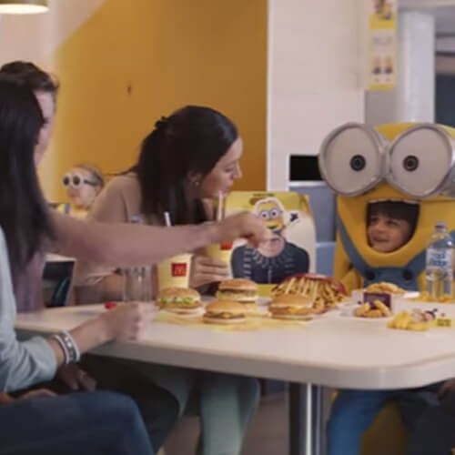 Child wearing Minion costumer with family at McDonalds