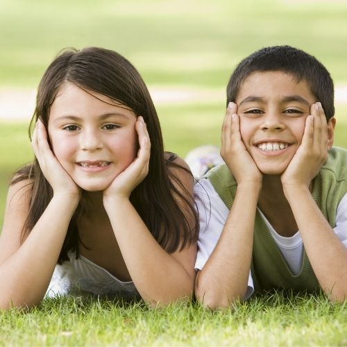 Two children lying in the park