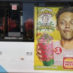 An ad on a bus of a boy holding a bursties frozen drink